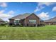 Spacious backyard boasts a well-maintained lawn and a charming deck with comfortable seating, perfect for outdoor relaxation at 4909 N Graystone Dr, Muncie, IN 47304