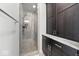 A glass enclosed shower with a rainfall shower head and decorative tile is accented by dark cabinets at 4909 N Graystone Dr, Muncie, IN 47304