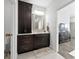 Modern bathroom featuring dark wood cabinets, marble countertops, and neutral tile flooring at 4909 N Graystone Dr, Muncie, IN 47304