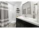This powder room offers an updated vanity with storage and a shower-tub combo with stylish shower curtain at 4909 N Graystone Dr, Muncie, IN 47304