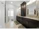 The luxurious bathroom offers double sinks, granite countertops, and a decorative cabinet for storage at 4909 N Graystone Dr, Muncie, IN 47304
