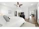 The sunny bedroom features hardwood floors, a ceiling fan, and access to a private bathroom at 4909 N Graystone Dr, Muncie, IN 47304
