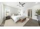 The primary bedroom features a ceiling fan, hardwood floors, and large windows for lots of natural light at 4909 N Graystone Dr, Muncie, IN 47304