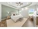 This primary bedroom boasts a tray ceiling, stylish decor, and tons of natural light from the dual windows at 4909 N Graystone Dr, Muncie, IN 47304