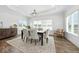 Elegant dining room features hardwood floors, bright windows, and stylish chandelier at 4909 N Graystone Dr, Muncie, IN 47304