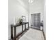 Bright foyer features hardwood floors, a stylish console table, and neutral decor creating an inviting entrance at 4909 N Graystone Dr, Muncie, IN 47304
