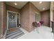 Inviting front porch with seasonal flowers and tasteful decor creating a warm welcome to this beautiful home at 4909 N Graystone Dr, Muncie, IN 47304