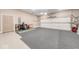 Spacious three car garage with painted walls and sealed concrete floor offering ample parking and storage at 4909 N Graystone Dr, Muncie, IN 47304