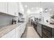 Modern kitchen with white cabinets, stainless appliances, and marble countertops at 4909 N Graystone Dr, Muncie, IN 47304