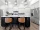 Island kitchen with white cabinets, stainless appliances, and stylish pendant lighting at 4909 N Graystone Dr, Muncie, IN 47304