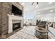 Inviting living room with a stone fireplace, large windows, and contemporary decor at 4909 N Graystone Dr, Muncie, IN 47304