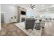 Open-concept living room featuring a stone fireplace, hardwood floors, and modern furnishings at 4909 N Graystone Dr, Muncie, IN 47304