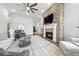 Stylish living room boasts a stone fireplace, hardwood floors, and an open layout at 4909 N Graystone Dr, Muncie, IN 47304