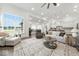 Spacious, light-filled living room featuring large windows, hardwood floors, and modern furnishings at 4909 N Graystone Dr, Muncie, IN 47304