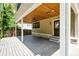 Inviting back porch offers outdoor living space with a stained wood ceiling and ceiling fan at 5930 Broadway St, Indianapolis, IN 46220