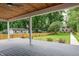 Open backyard with a deck and a fenced-in area, surrounded by lush greenery and trees at 5930 Broadway St, Indianapolis, IN 46220