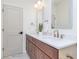 Bright bathroom featuring a double vanity with elegant marble countertops and modern fixtures at 5930 Broadway St, Indianapolis, IN 46220