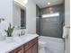 Bathroom featuring white marble countertops, a bathtub, and modern fixtures at 5930 Broadway St, Indianapolis, IN 46220