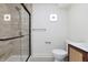 Modern bathroom featuring a tiled shower, a glass door, and stylish vanity at 5930 Broadway St, Indianapolis, IN 46220