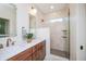 Bathroom featuring double sink vanity, a glass shower, and marble countertops at 5930 Broadway St, Indianapolis, IN 46220