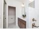 Bathroom featuring wainscotting and a double sink with marble countertops at 5930 Broadway St, Indianapolis, IN 46220