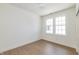 Clean, bright bedroom featuring hardwood floors and a large window offering ample natural light at 5930 Broadway St, Indianapolis, IN 46220