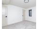 An empty bedroom showcases neutral paint, modern lighting, and soft, neutral carpeting at 5930 Broadway St, Indianapolis, IN 46220