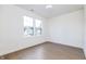 Empty bedroom featuring hardwood floors and a view to the neighborhood at 5930 Broadway St, Indianapolis, IN 46220