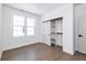 Bright bedroom with hardwood floors, a large window, a closet, and a contemporary design at 5930 Broadway St, Indianapolis, IN 46220