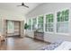 Bright bedroom featuring hardwood floors, a ceiling fan, and built in storage at 5930 Broadway St, Indianapolis, IN 46220