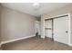 Neutral bedroom with hardwood floors, closet with sliding doors, and ample natural light at 5930 Broadway St, Indianapolis, IN 46220