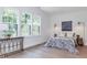 Bedroom featuring hardwood floors, a large window, and natural light at 5930 Broadway St, Indianapolis, IN 46220