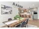 Open dining room with view of the kitchen, featuring modern lighting and an area rug at 5930 Broadway St, Indianapolis, IN 46220