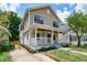 Charming two-story home with a welcoming front porch and beautifully landscaped front yard at 5930 Broadway St, Indianapolis, IN 46220