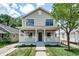 Charming two-story home with a covered front porch and a well-maintained lawn at 5930 Broadway St, Indianapolis, IN 46220