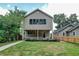 Charming two-story home with a well-manicured front yard and inviting porch at 5930 Broadway St, Indianapolis, IN 46220