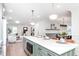 Open-concept kitchen island with marble countertops and seating, flowing into the living and dining areas at 5930 Broadway St, Indianapolis, IN 46220
