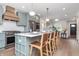 Beautiful kitchen with long island, seating, modern appliances, and hardwood floors at 5930 Broadway St, Indianapolis, IN 46220