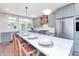 Modern kitchen with marble countertops, a large island, stainless steel appliances, and stylish pendant lights at 5930 Broadway St, Indianapolis, IN 46220