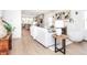 Inviting living room featuring hardwood floors and an open layout flowing into the kitchen at 5930 Broadway St, Indianapolis, IN 46220