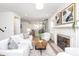 Bright living room with fireplace, mantel, and a seamless view into the modern kitchen at 5930 Broadway St, Indianapolis, IN 46220