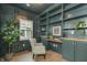 Home office boasts built in shelving, wainscoting, light wood floors and natural light at 5930 Broadway St, Indianapolis, IN 46220