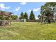 Spacious backyard featuring a storage shed, playset, and patio area for relaxation and entertainment at 6102 Boulder Dr, Anderson, IN 46013