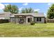 Backyard featuring a pergola-covered patio with a table and chairs in a well-maintained yard at 6102 Boulder Dr, Anderson, IN 46013