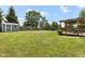 Large, well-maintained backyard featuring a storage shed, playset, and patio area at 6102 Boulder Dr, Anderson, IN 46013