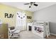Bright bedroom featuring a loft bed with storage and fun 'PLAY' and 'BUILD' wall decor for  at 6102 Boulder Dr, Anderson, IN 46013