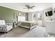 Comfortable bedroom with a plush bed, a ceiling fan, and lots of natural light from the windows at 6102 Boulder Dr, Anderson, IN 46013