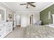 Spacious bedroom with neutral walls, a ceiling fan, plush carpeting and a comfortable upholstered chair at 6102 Boulder Dr, Anderson, IN 46013