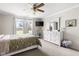 Bright bedroom features a large window, a ceiling fan, and a neutral color palette for a calming atmosphere at 6102 Boulder Dr, Anderson, IN 46013