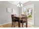 Charming dining area with a wood table and chairs, leading to a sliding door and backyard view at 6102 Boulder Dr, Anderson, IN 46013